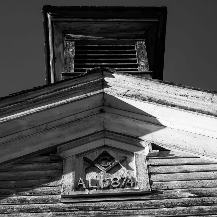 Looking up at the Masonic building seeing the Masonic Crest and roof line