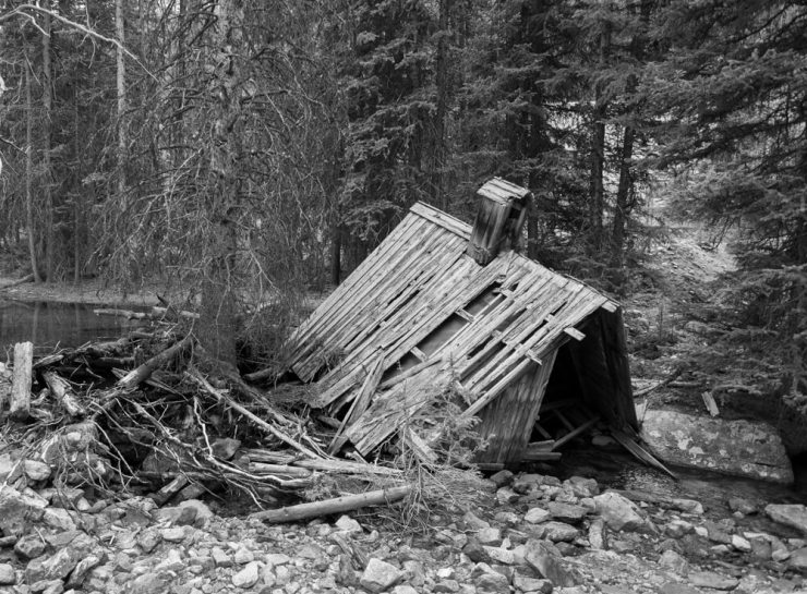 The school house roof sits in Elkhorn creek creating a partial dam on the stream.