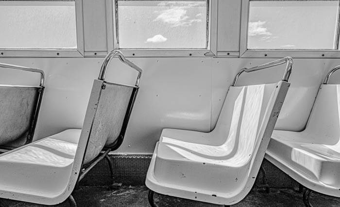 Plastic seats under a window on the ferry to North Haven